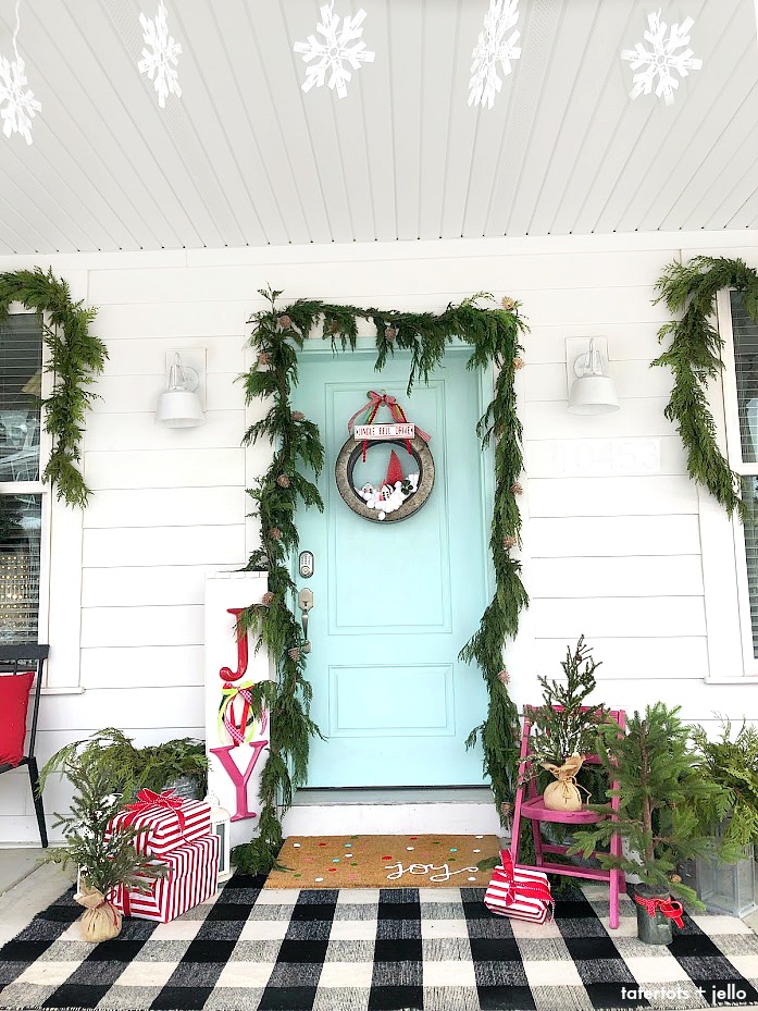 Joy to the World Holiday Porch. Bright colors, a GIANT Joy sign, Snowball Wreath and hand-painted rug create a happy welcome for family and friends with holiday season! 