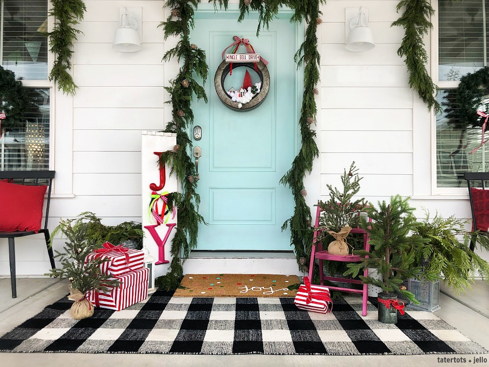 Joy to the World Holiday Porch. Bright colors, a GIANT Joy sign, Snowball Wreath and hand-painted rug create a happy welcome for family and friends with holiday season! 