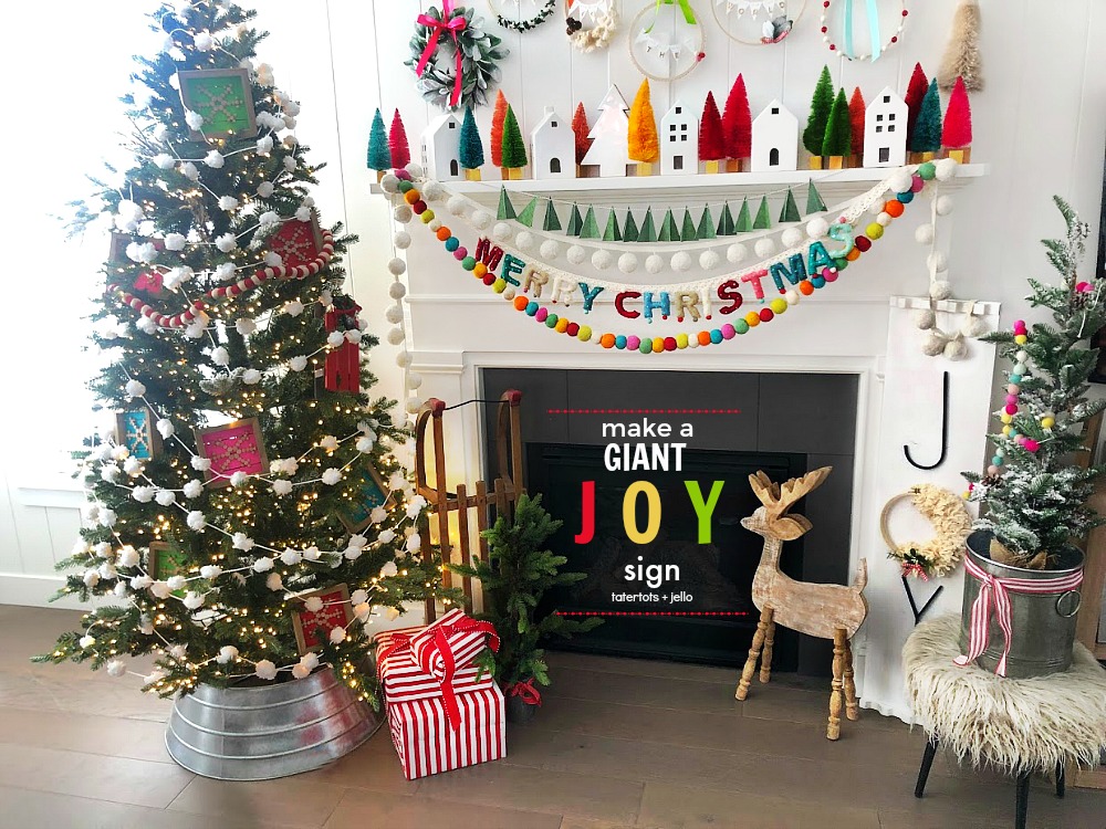 Make a GIANT JOY sign for under $10. An unfinished board, trim, embroidery hoop, yarn, letters and spray paint combine to create something special for the holidays!