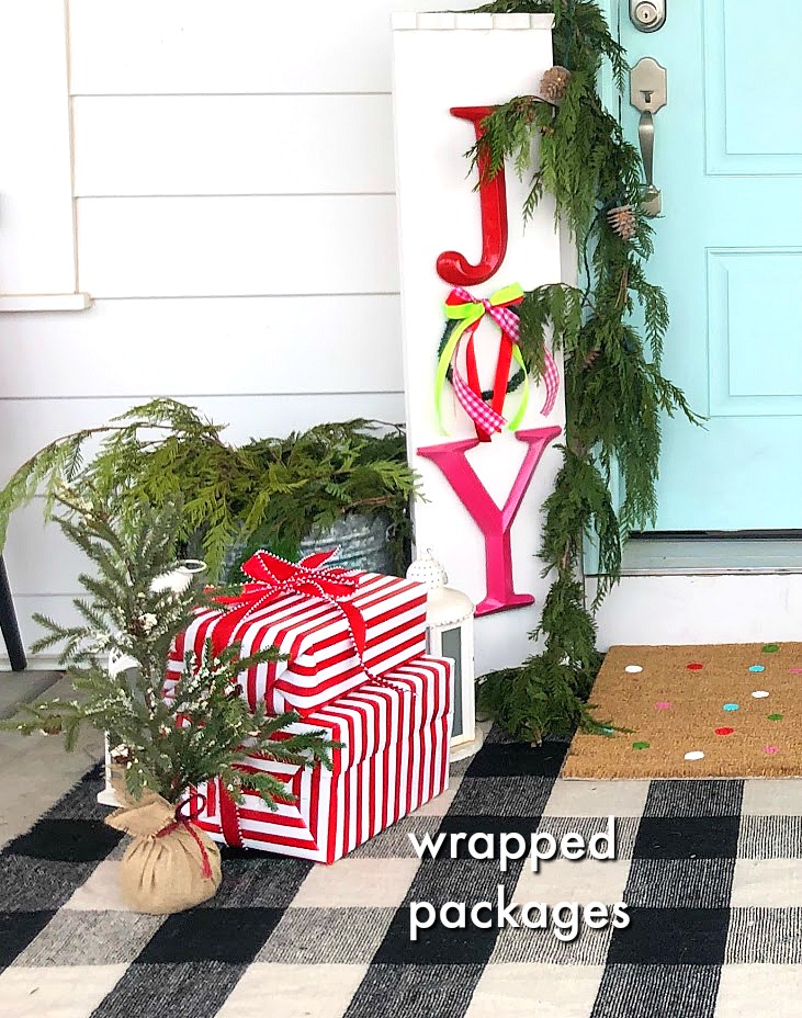 Joy to the World Holiday Porch. Bright colors, a GIANT Joy sign, Snowball Wreath and hand-painted rug create a happy welcome for family and friends with holiday season! 