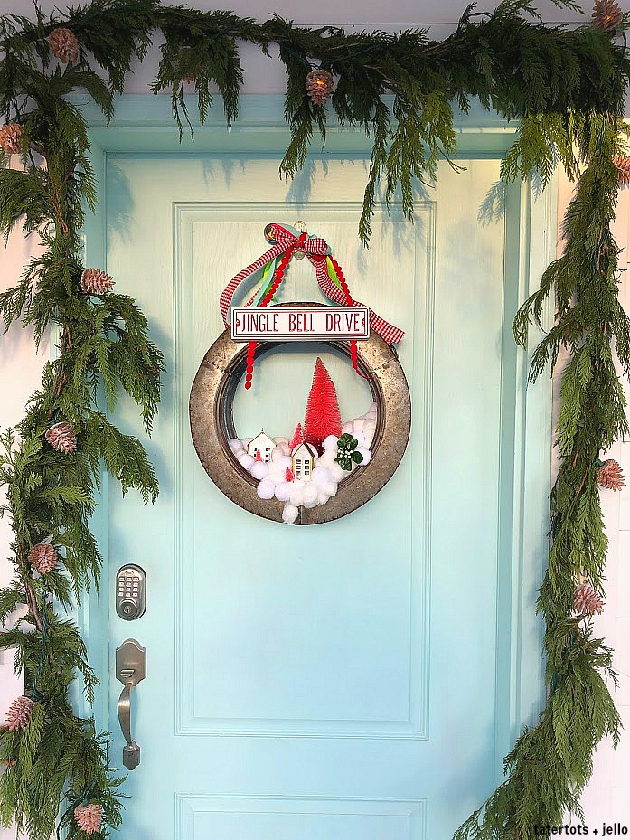 Farmhouse Industrial Snowball Wreath. Make a whimsical snowball wreath with a modern galvanized base, cotton balls, little houses and trees. 
