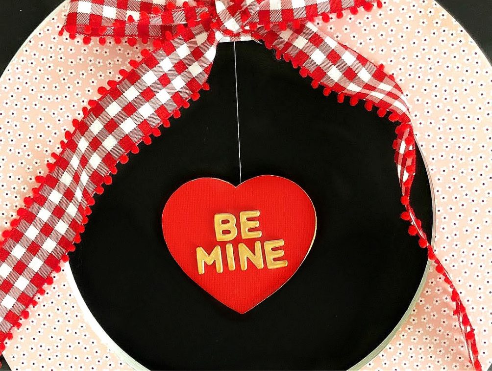 Valentine's Day Floating Conversation Heart Wreath. Turn your favorite paper into a cute wreath for Valentine's Day and add a floating heart with a Valentine's Day saying!