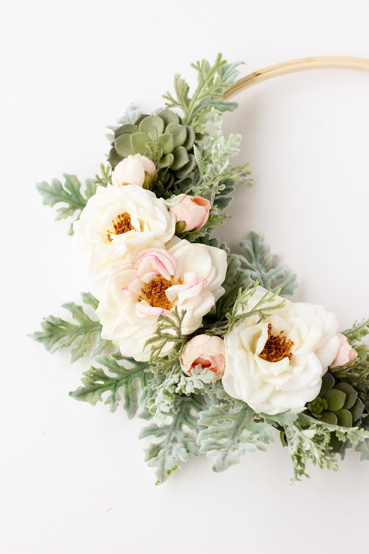 modern metal hoop wreath with white flowers. 