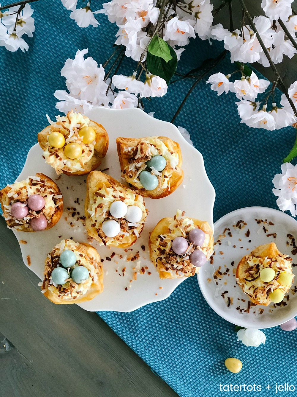 Robin Nests with Whipped Cream Filling - the perfect Spring and Easter treat! Flaky layers of baked puff pastry dough cups cradle creamy, whipped filling topped by toasted coconut and rich chocolate eggs. Bake up a beautiful dessert for Spring and Easter in just minutes!