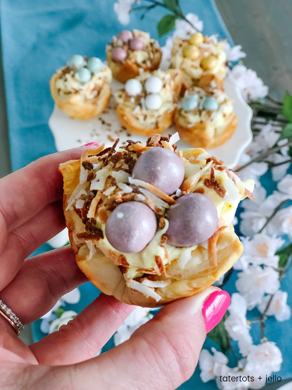 Robin Nests with Whipped Cream Filling - the perfect Spring and Easter treat! Flaky layers of baked puff pastry dough cups cradle creamy, whipped filling topped by toasted coconut and rich chocolate eggs. Bake up a beautiful dessert for Spring and Easter in just minutes! 
