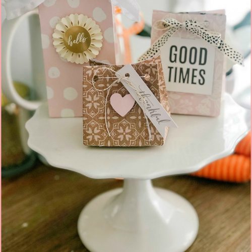 Make a custom gift bag out of a sheet of scrapbook paper! Gift bags are so easy to make and personalize for parties, special occasions and special gifts. I'll show you how to do this with the We R Memory Keepers Gift Bag Punch Board.