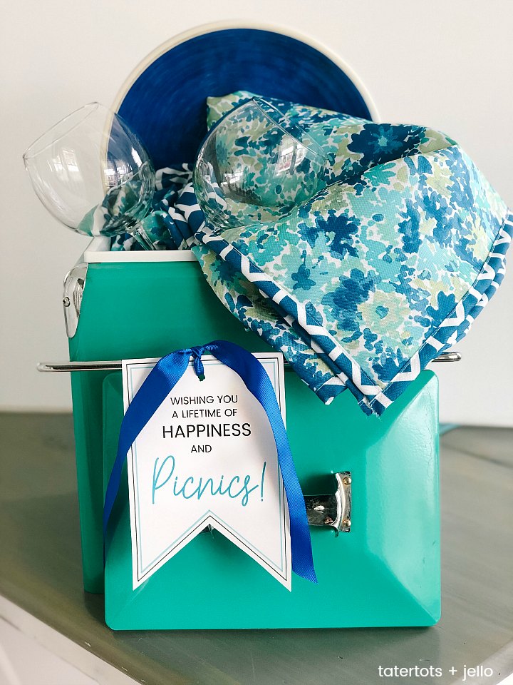 Picnic Basket Wedding Gift Idea and Free Printable Tag. Looking for the perfect wedding or newlywed gift? A picnic basket filled with a handy picnic blanket, plates and glasses and a cute printable tag is something the happy couple will use for years to come! ﻿