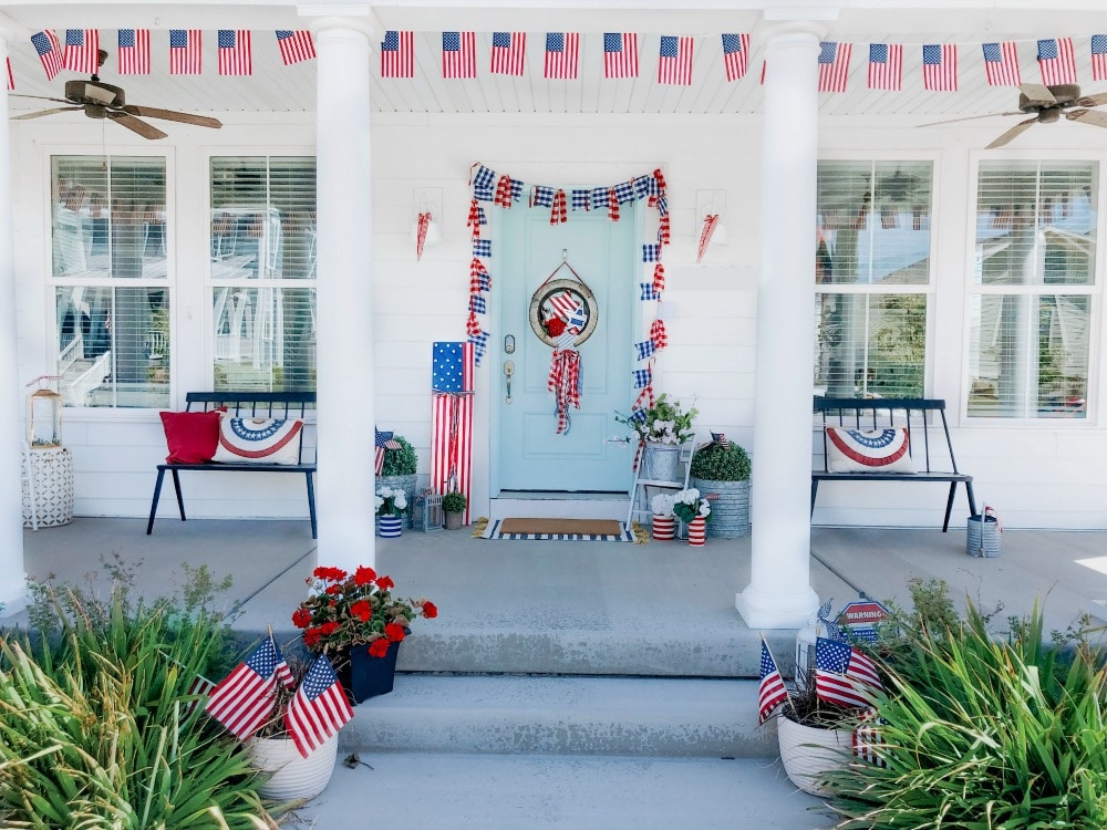 Patriotic Flag Fourth of July Porch. 6 Simple ways to create a bright and colorful porch for the Fourth of July. A handmade giant flag sign, flag wreath, banners and more!