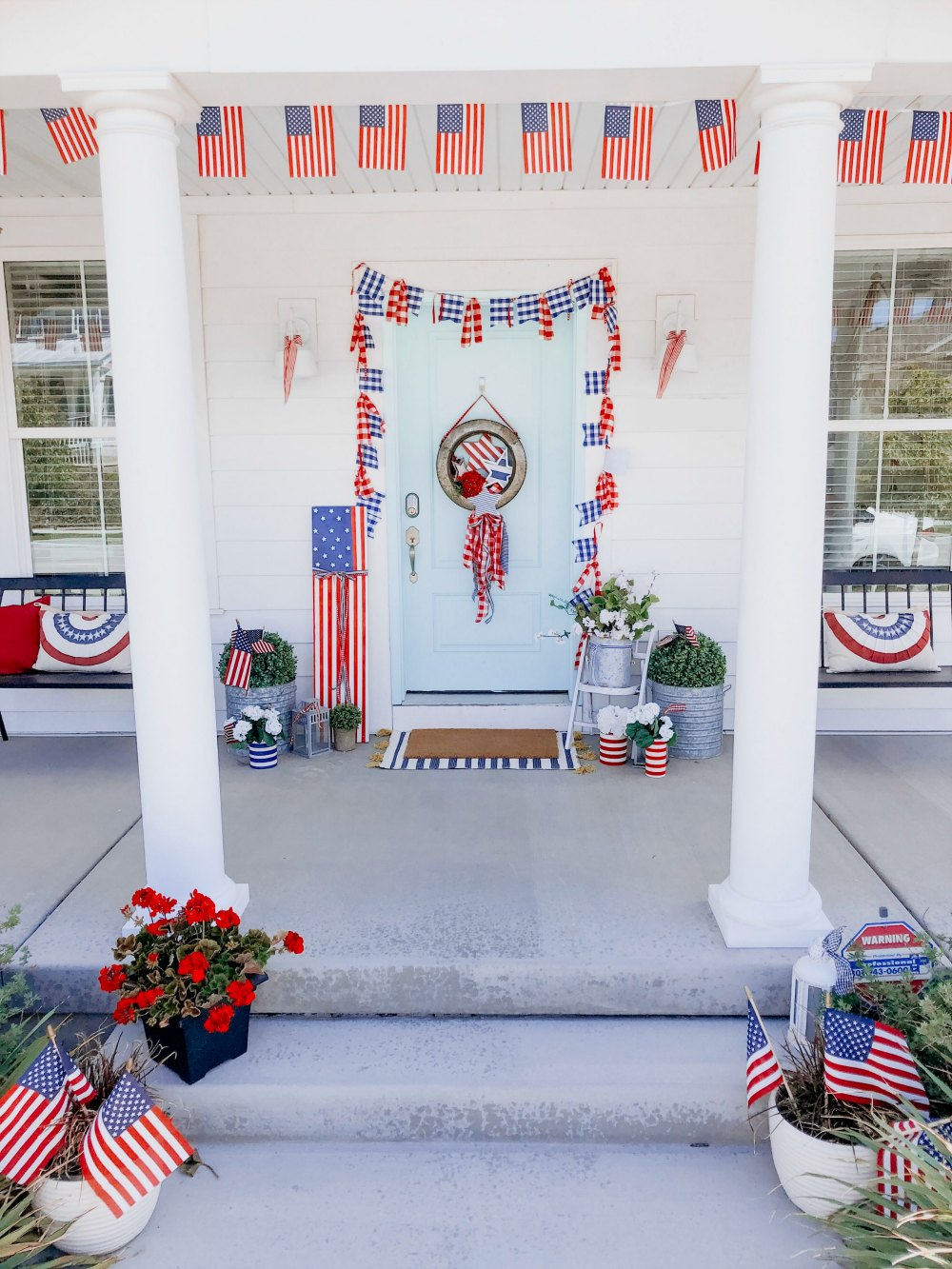 Patriotic Flag Fourth of July Porch. 6 Simple ways to create a bright and colorful porch for the Fourth of July. A handmade giant flag sign, flag wreath, banners and more! 