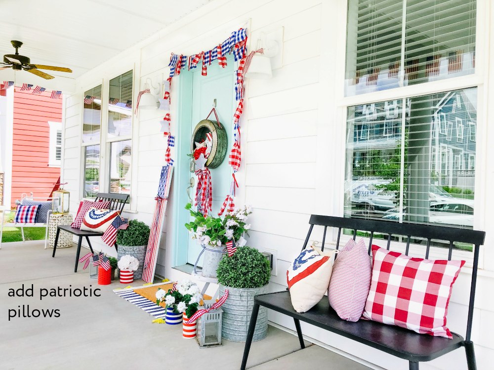 Patriotic Flag Fourth of July Porch. 6 Simple ways to create a bright and colorful porch for the Fourth of July. A handmade giant flag sign, flag wreath, banners and more! 