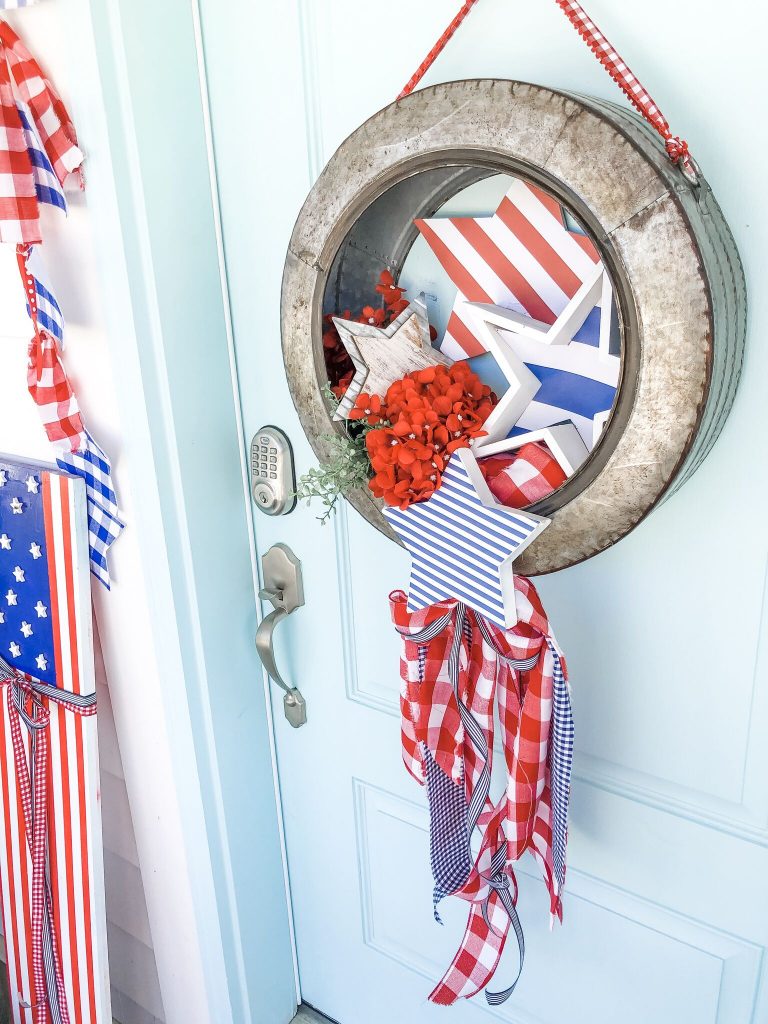 Patriotic Flag Fourth of July Porch. 6 Simple ways to create a bright and colorful porch for the Fourth of July. A handmade giant flag sign, flag wreath, banners and more!