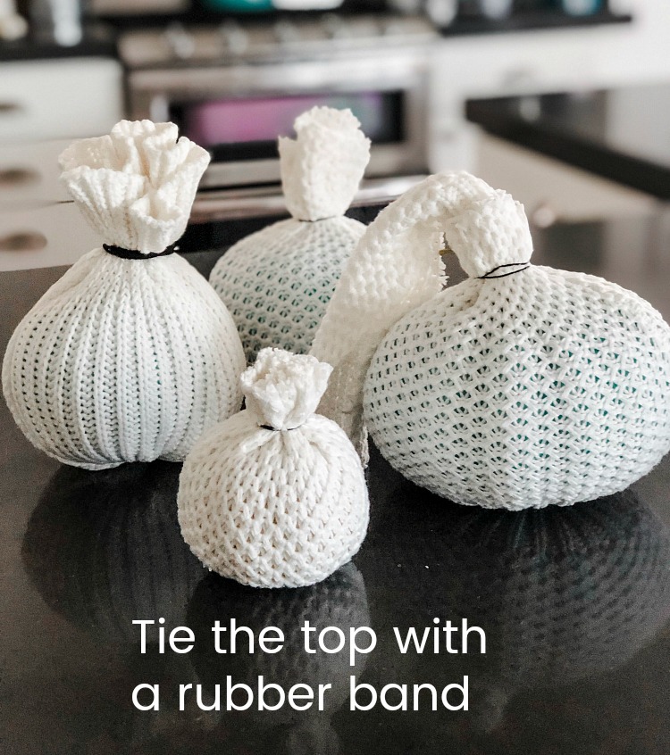 How to make easy fall sweater pumpkins. Use inexpensive dollar store pumpkins and transform them into beautiful decor with thrifted sweaters! 