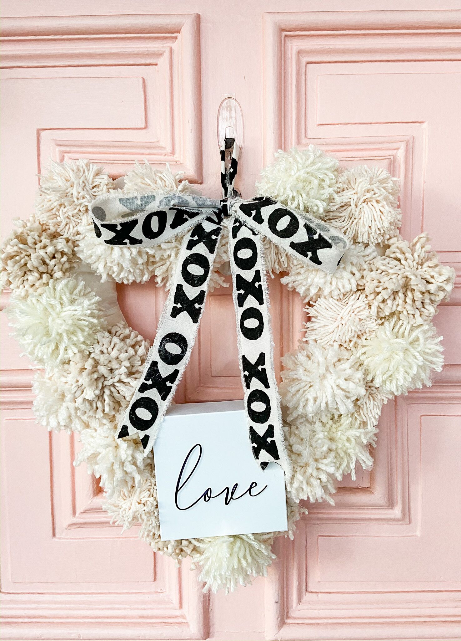 How to Make a Valentine Heart Pom Pom Yarn Wreath. Brighten up your door this winter with a textured pom pom wreath for valentine's Day!