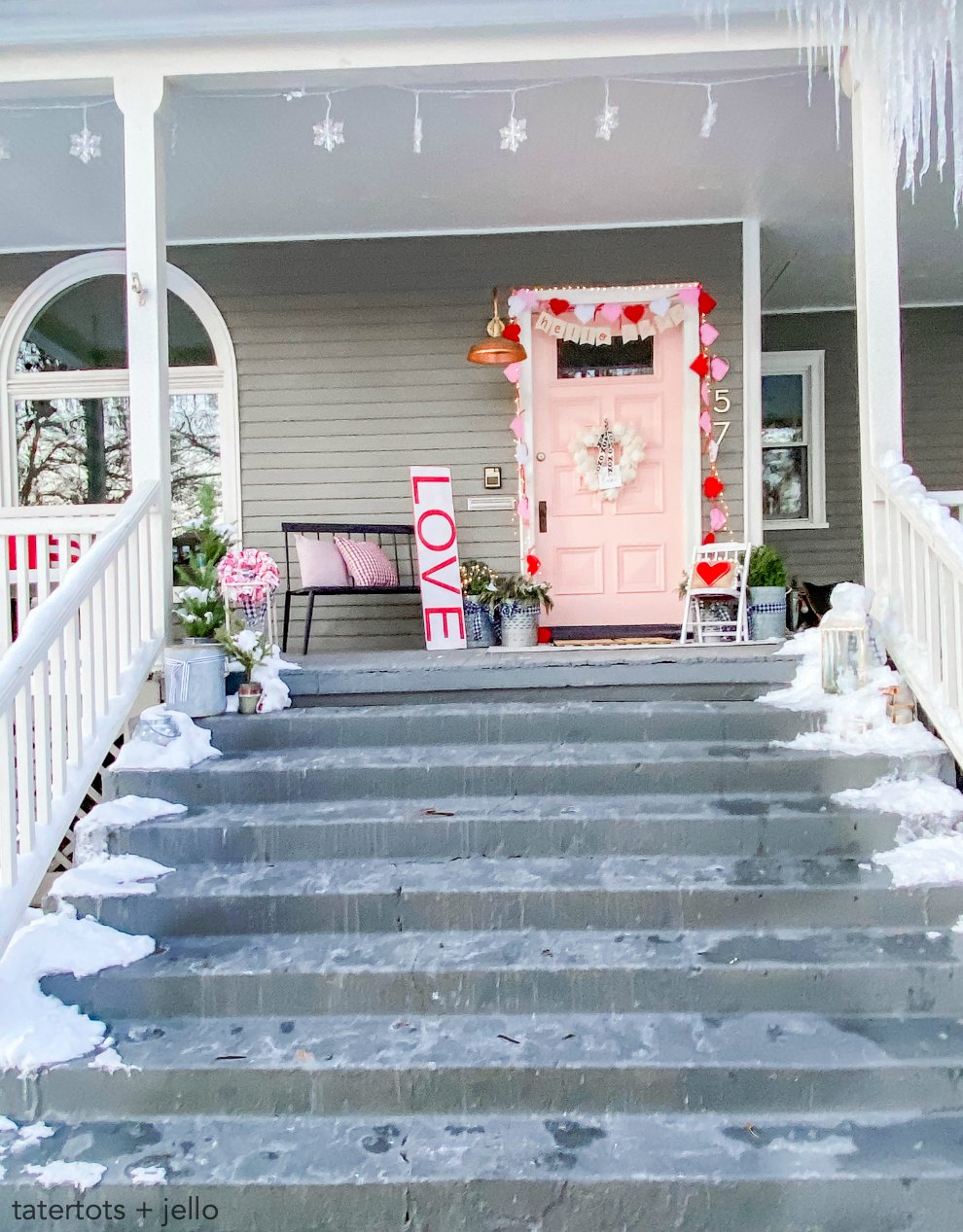 Pink and Red Valentine's Porch. Make a DIY garland, sign, banner, pillow and wreath to create a bright and colorful porch for Valentine's Day! 