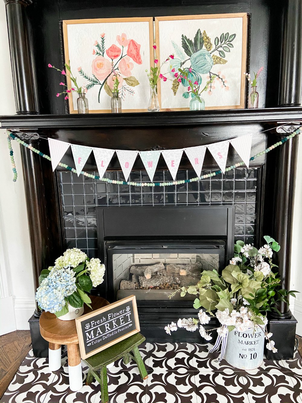 Simple Spring Flower Mantel. Colorful flower art, sweet vases of flowers and a handmade banner are easy to put together to bring some Spring sunshine to your mantel.