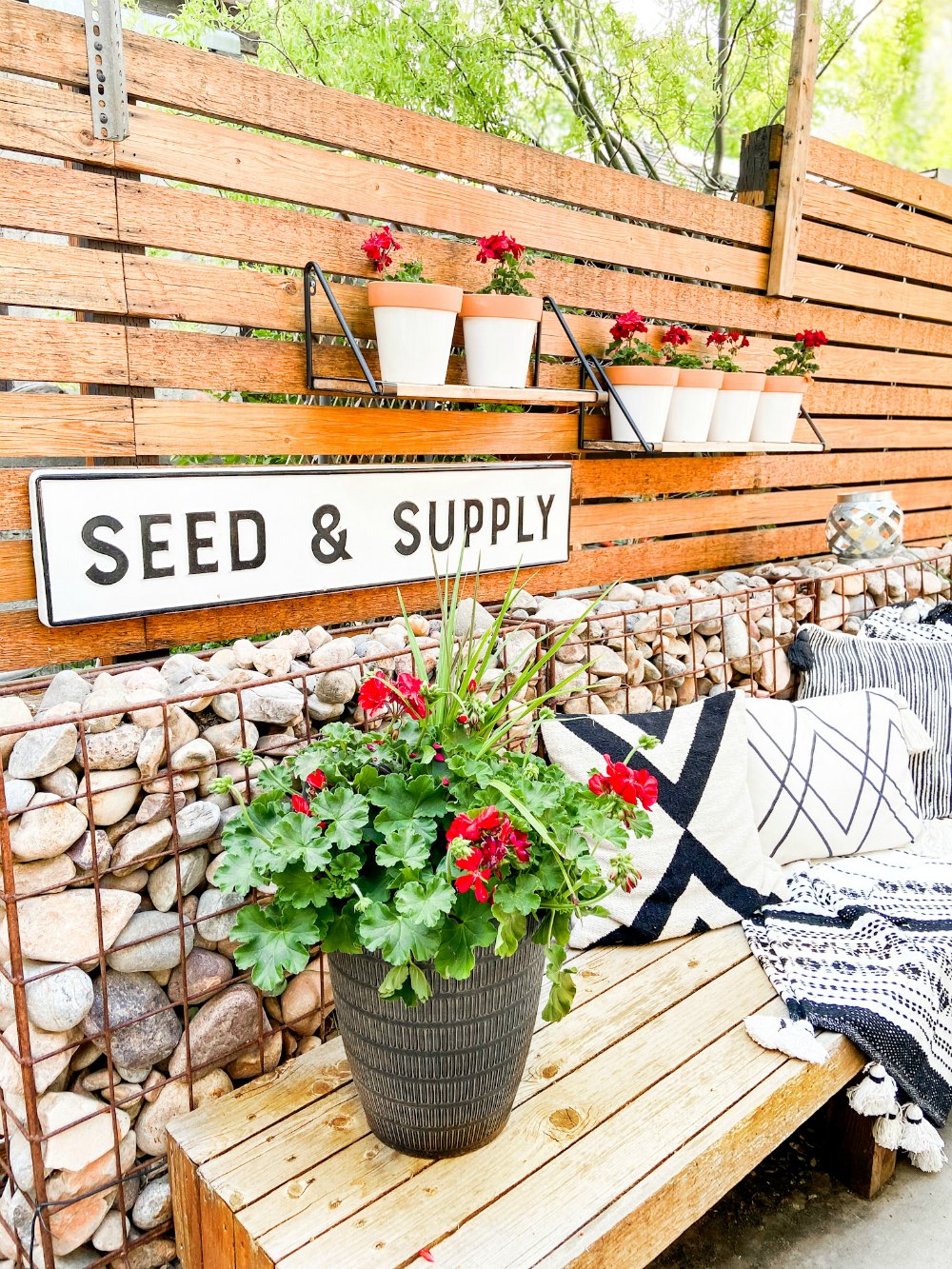 DIY Hanging Patio Garden. Make the most of your patio space by hanging shelves and planting flowers or herbs in painted pots! 