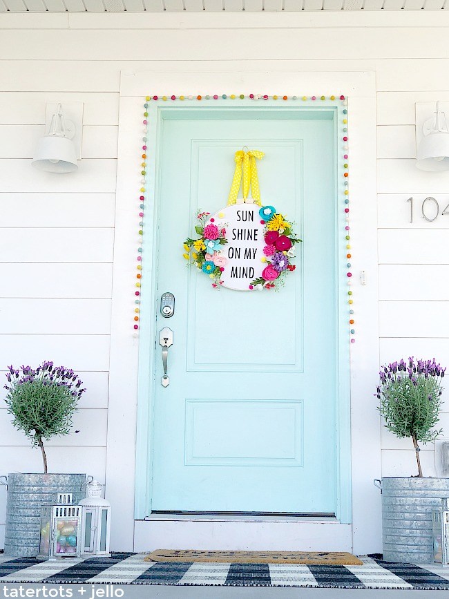 How to make a felt flower embroidery hoop saying wreath. Create a saying for spring and put it inside an embroidery hoop with felt flowers. It’s fun to make and will welcome visitors to your home all summer long!