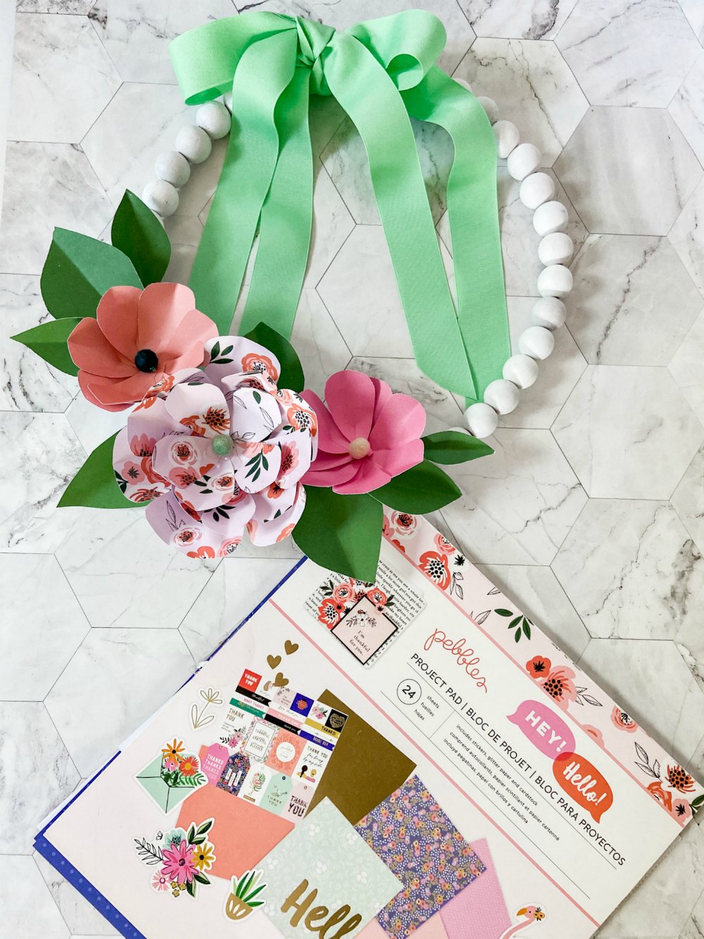 Wood Bead Wreath with Paper Flowers. Make this trendy wood bead wreath and create easy paper flowers with free petal and leaves template!