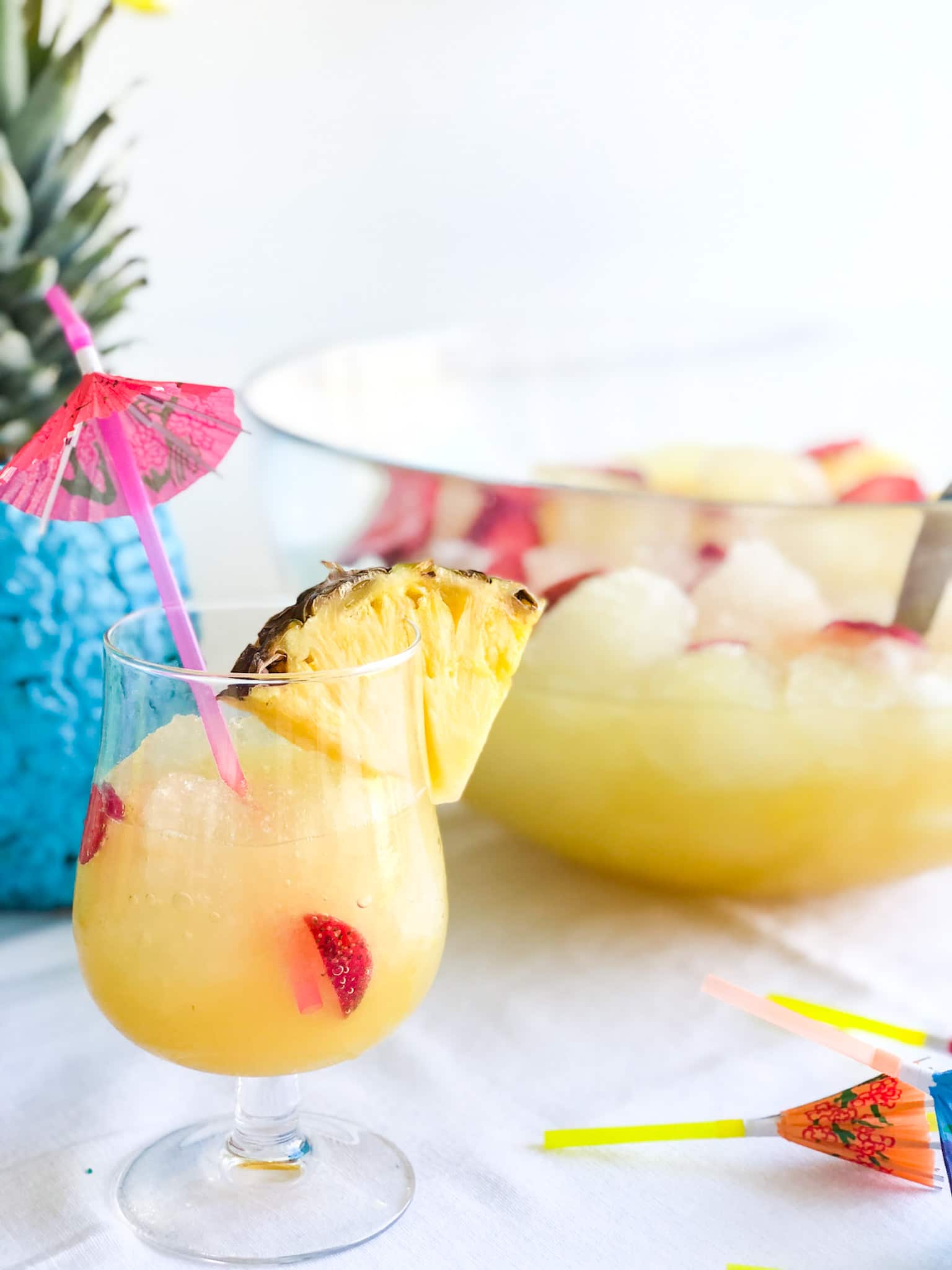 Pineapple Lime Luau Slushy Punch is a party must! Refreshing pineapple and tangy lime combine favors in this fizzy, fruity, slushy punch that makes enough for a crowd!