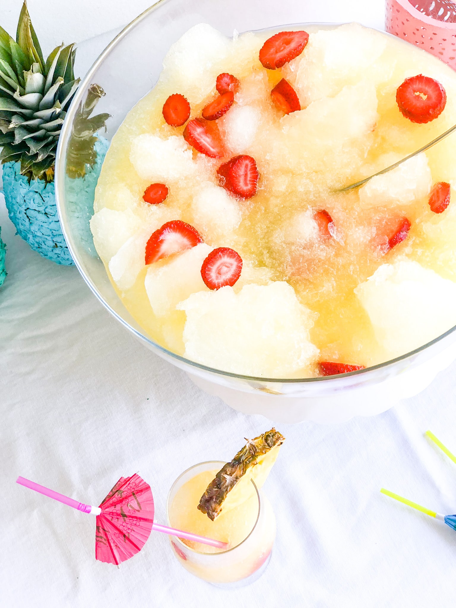 Pineapple Lime Luau Slushy Punch is a party must! Refreshing pineapple and tangy lime combine favors in this fizzy, fruity, slushy punch that makes enough for a crowd!