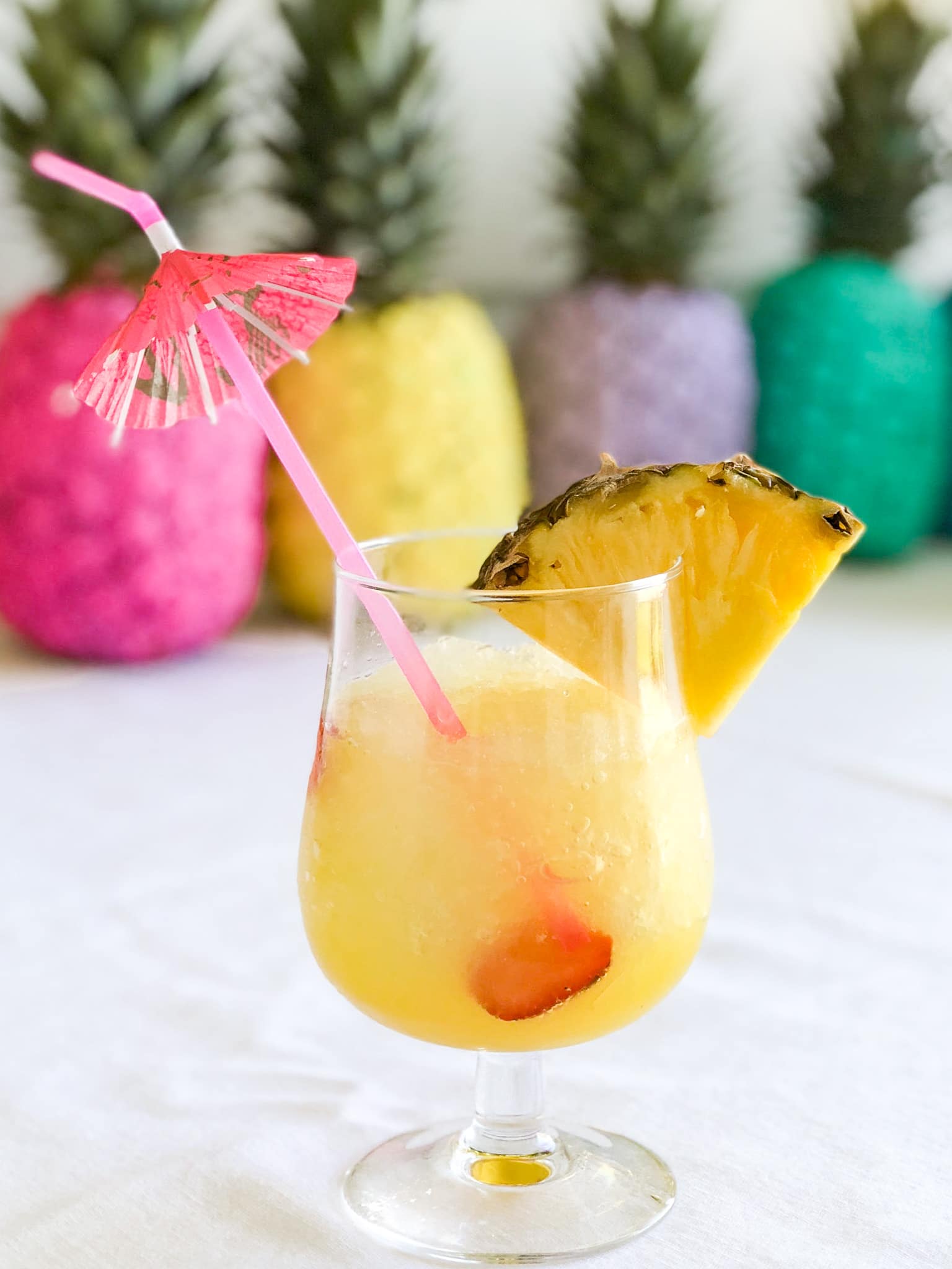 Pineapple Lime Luau Slushy Punch is a party must! Refreshing pineapple and tangy lime combine favors in this fizzy, fruity, slushy punch that makes enough for a crowd!