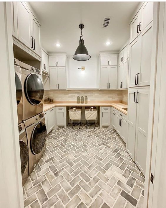 brick and neutral laundry room.