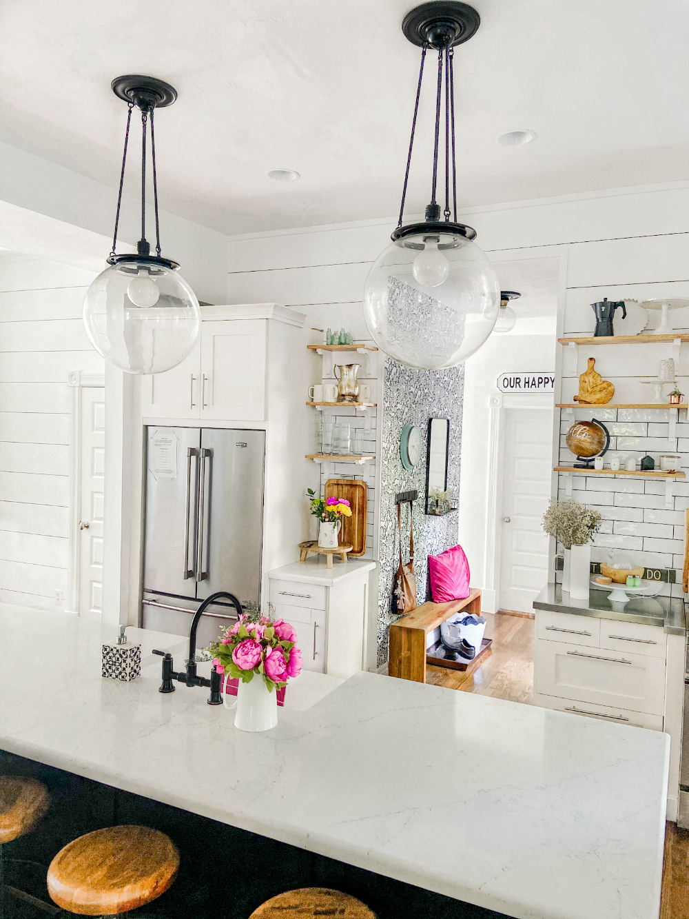 Kitchen remodel with planked walls and counter-depth fridge. 