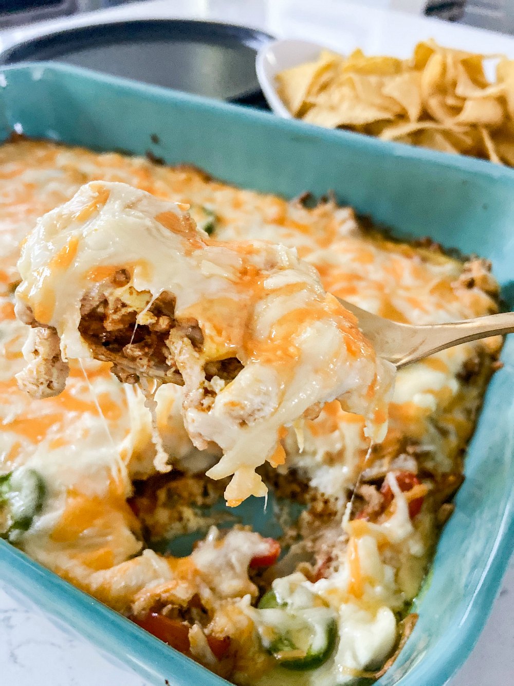 Low Carb Cheesy Taco Bake - Keto. A cheesy keto taco casserole that is the perfect topping over salads for you and over chips for your kids! All of the taste of tacos with a fractions of the carbs! 