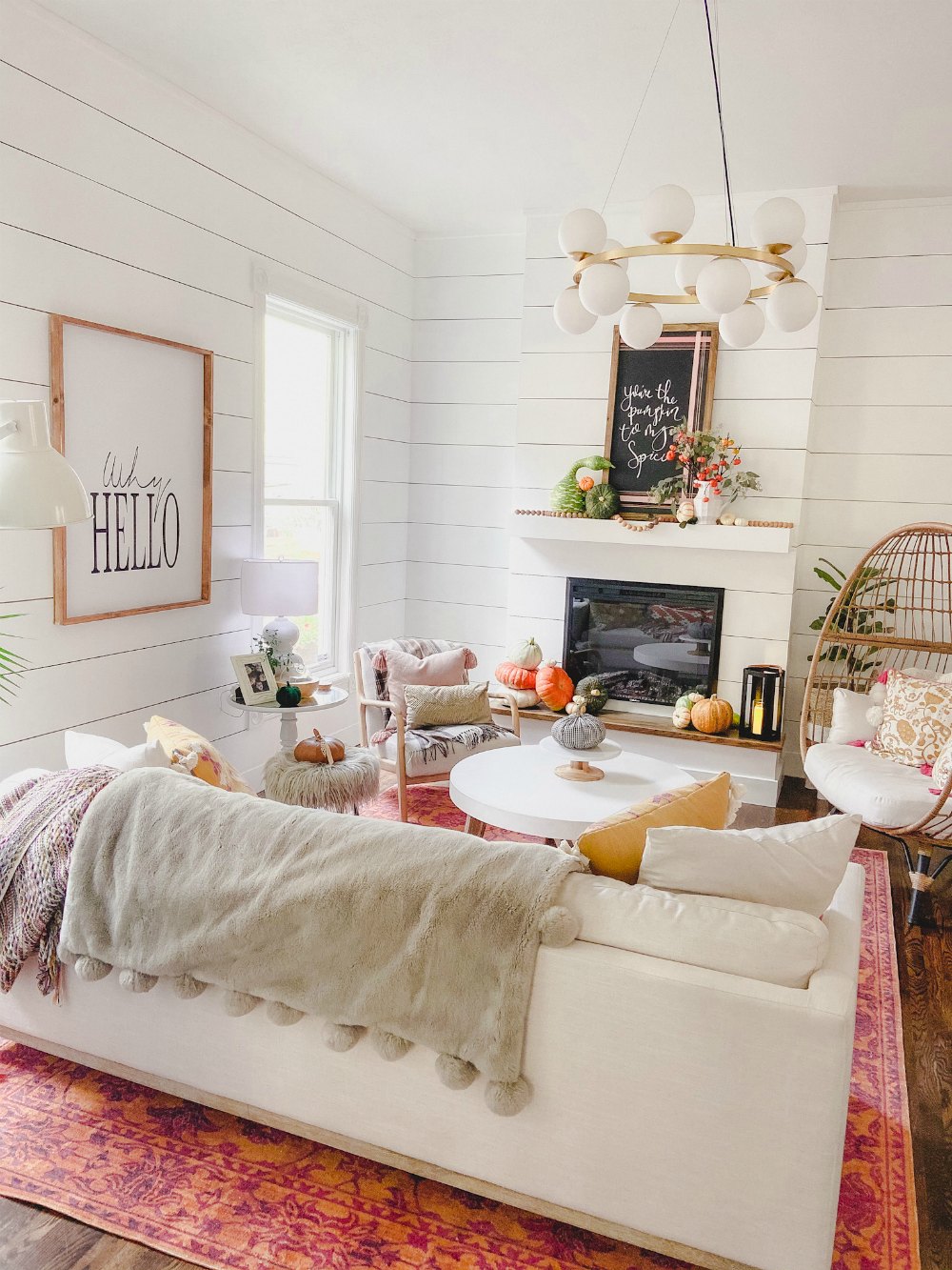 Colorful fall family room and natural pumpkin mantel.