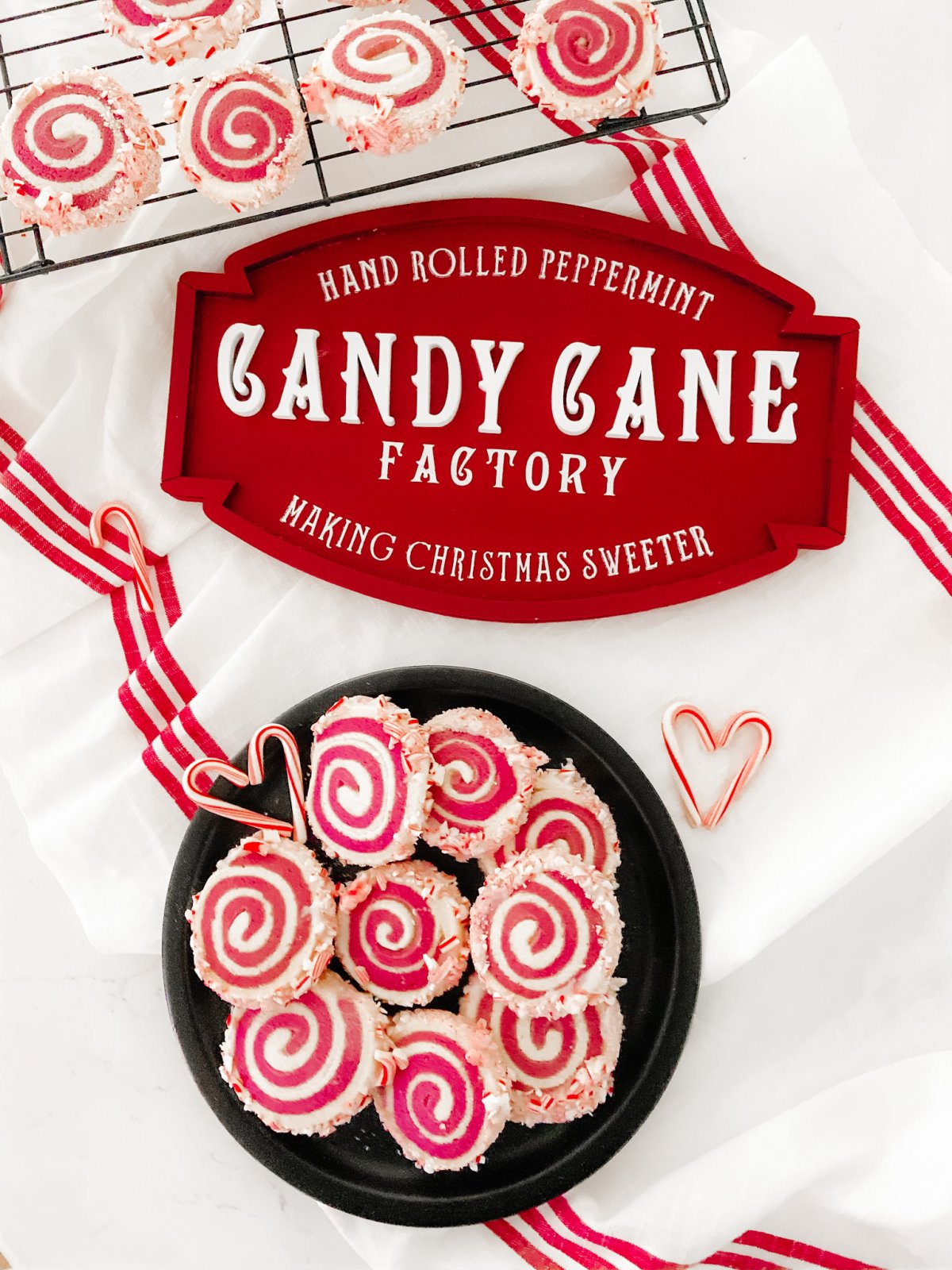 Candy Cane Frosted Swirl Cookies. Take the classic candy cane cookie and give it a modern update by rolling it and frosting it with crushed candy canes!