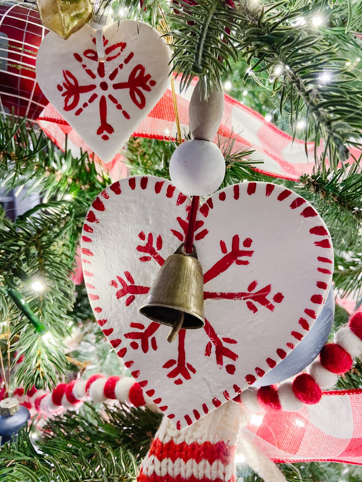 Candy Cane Themed Christmas Tree. Celebrate Christmas with a festive red and white tree filled with candy cane-themed projects, bells and felted garlands.