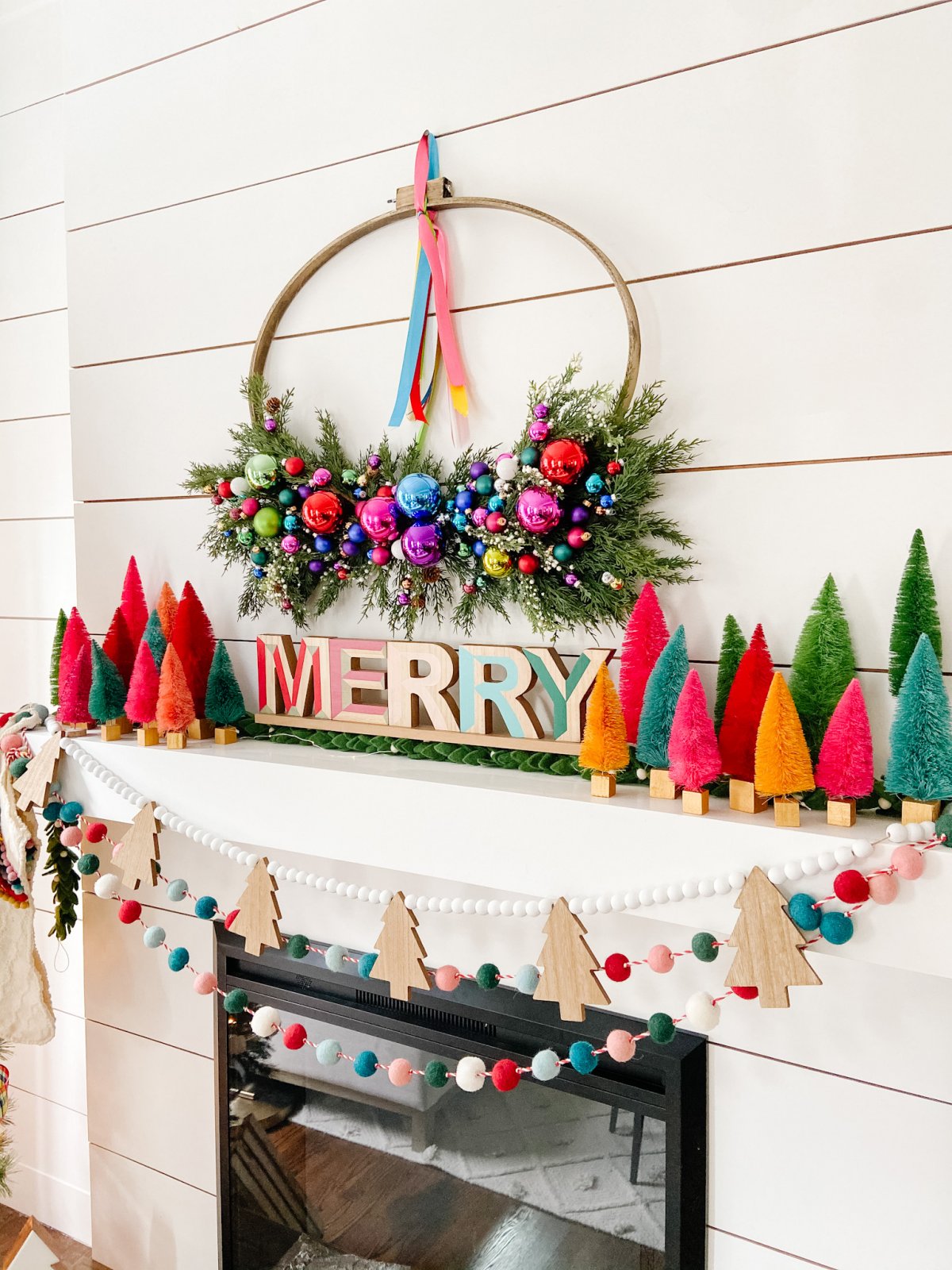 Colorful Holiday Embroidery Hoop Ornament Wreath. Create a stunning holiday wreath with inexpensive ornaments, faux greens and a simple embroidery hoop. 