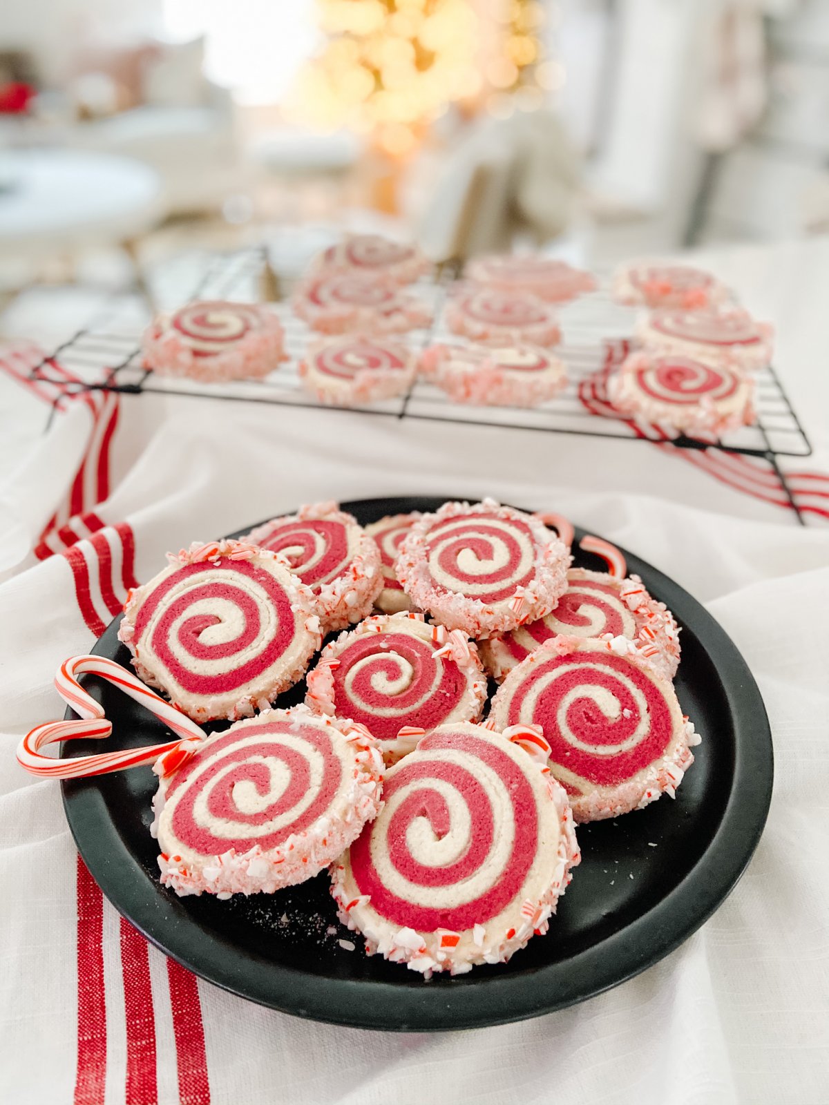 Candy Cane Frosted Swirl Cookies. Take the classic candy cane cookie and give it a modern update by rolling it and frosting it with crushed candy canes!