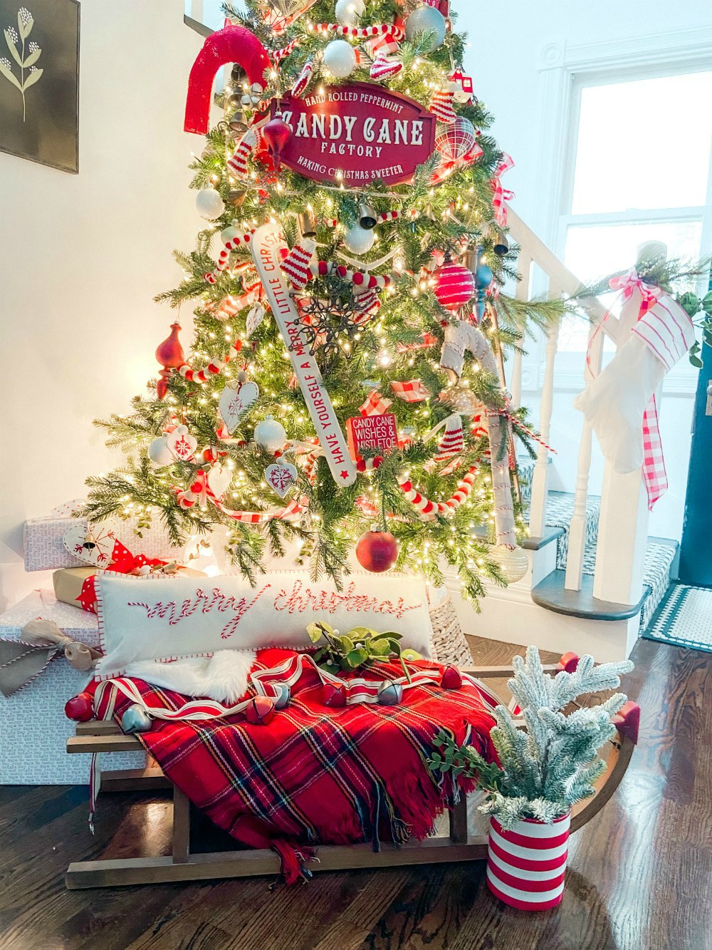 Candy Cane Themed Christmas Tree. Celebrate Christmas with a festive red and white tree filled with candy cane-themed projects, bells and felted garlands. 