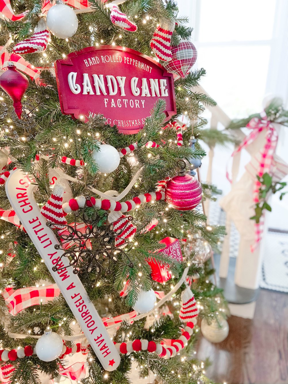 Candy Cane Themed Christmas Tree. Celebrate Christmas with a festive red and white tree filled with candy cane-themed projects, bells and felted garlands. 
