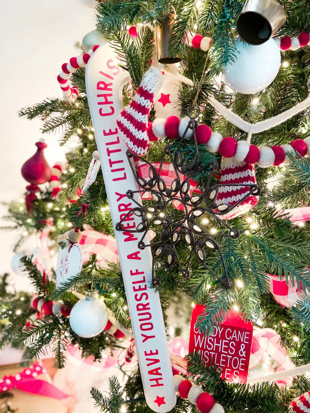 Candy Cane Themed Christmas Tree. Celebrate Christmas with a festive red and white tree filled with candy cane-themed projects, bells and felted garlands. 