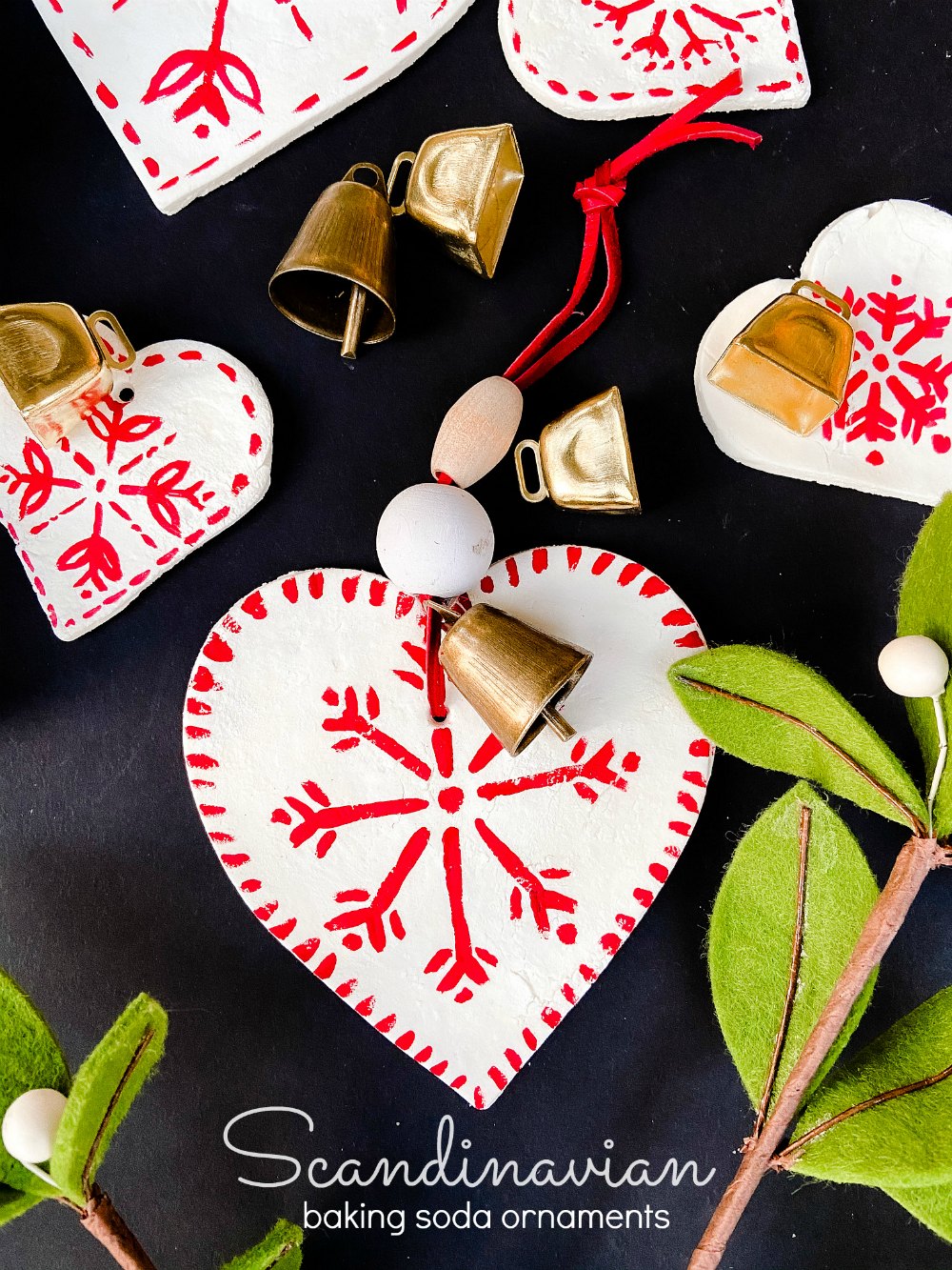 Scandinavian Painted Baking Soda Heart Ornaments. Use THREE simple kitchen ingredients to make adorable holiday ornaments and paint them with your kids! 