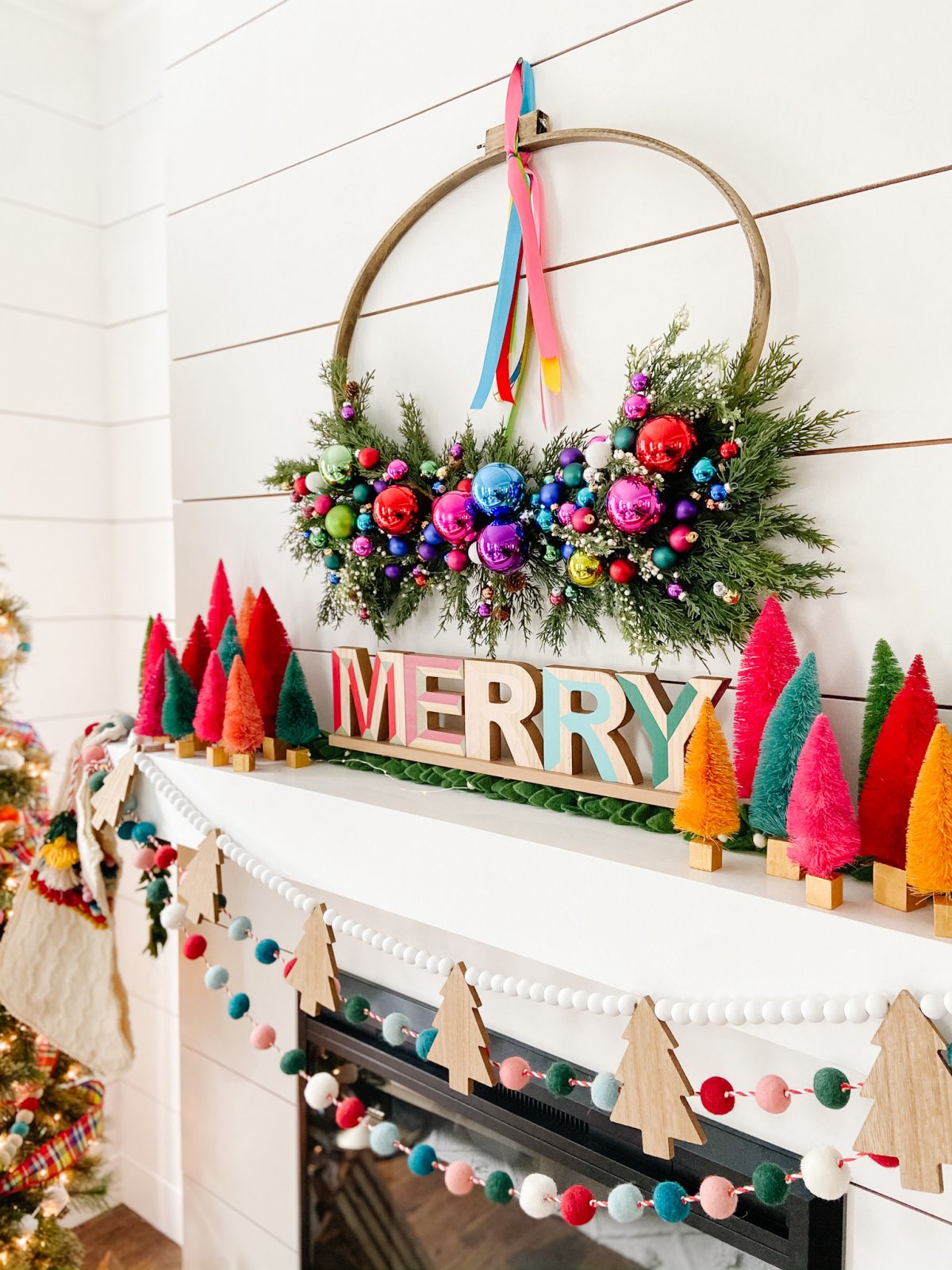 Bright Colorful Merry Mantel. Create colorful holiday cheer with a bright garland, little bottlebrush trees and an embroidery hoop ornament wreath!