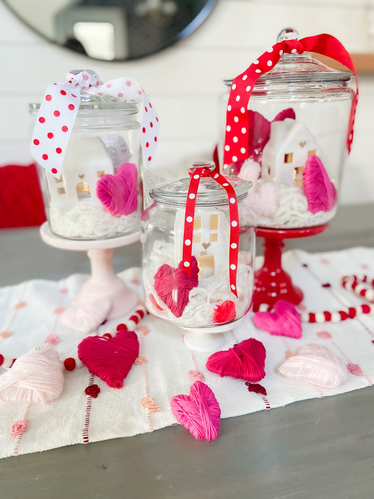 Valentine's Day Yarn-Wrap Cardboard Hearts + Centerpiece. Yarn-wrapped cardboard hearts are so simple to make and can be used for all kinds of Valentine's Day crafts. Add them to clear jars for a pretty centerpiece idea!