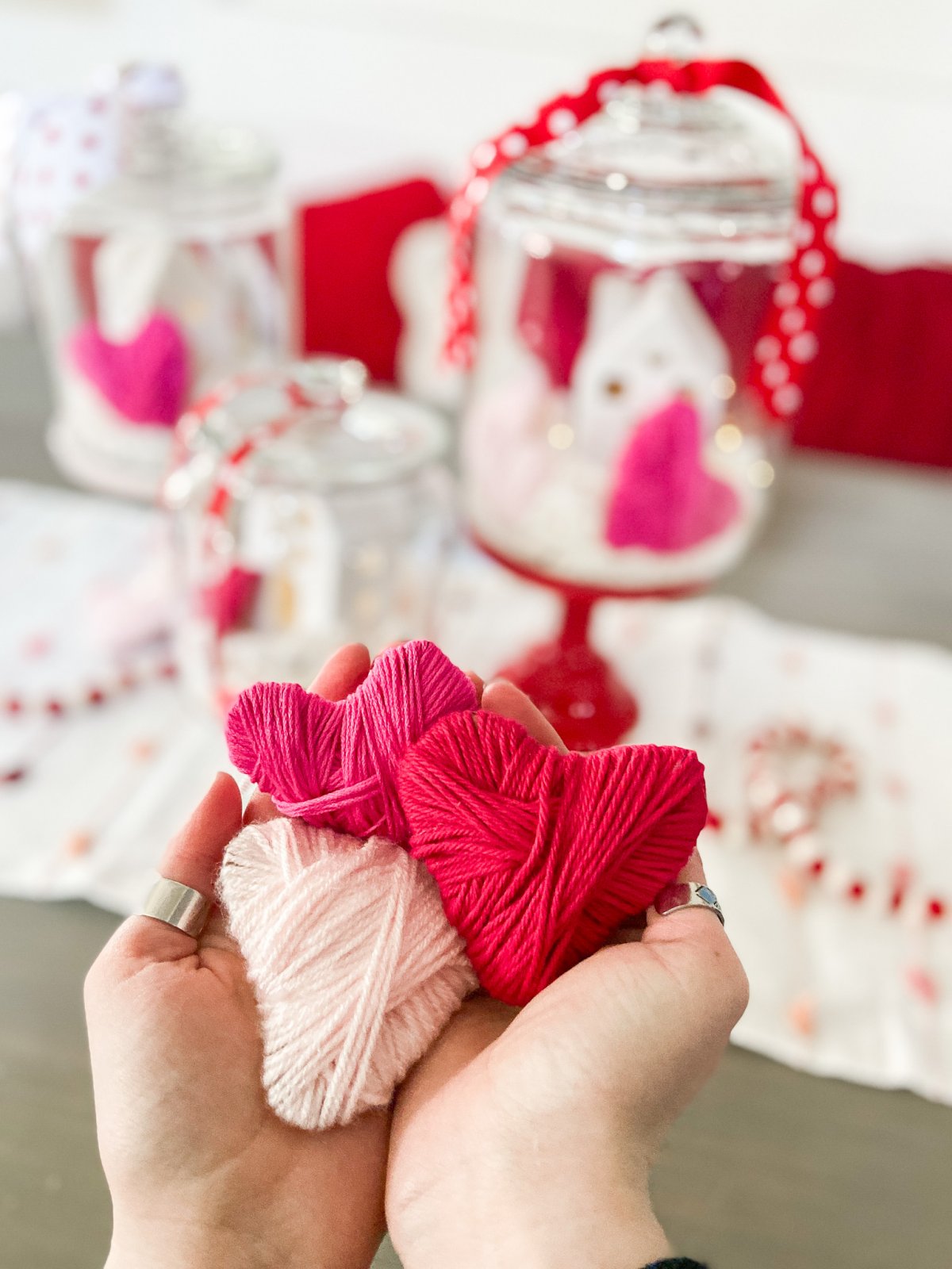 Valentine's Day Yarn-Wrap Cardboard Hearts + Centerpiece. Yarn-wrapped cardboard hearts are so simple to make and can be used for all kinds of Valentine's Day crafts. Add them to clear jars for a pretty centerpiece idea!