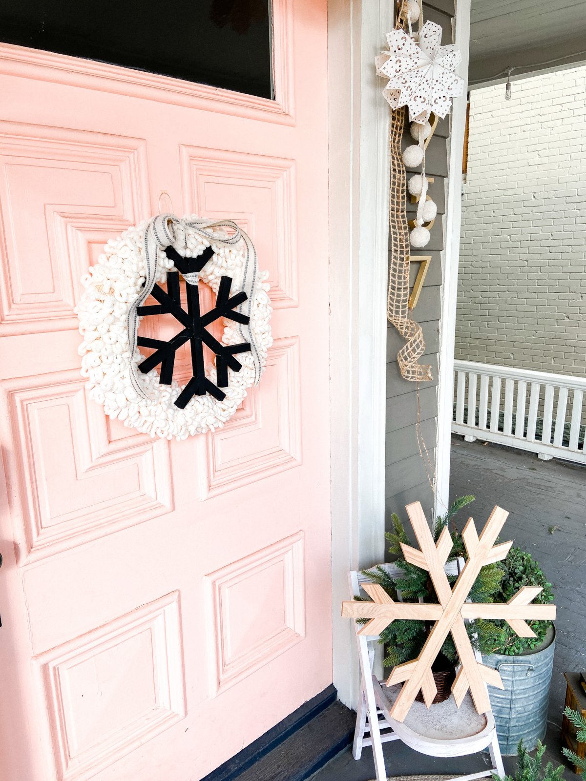 DIY Winter Wood and Yarn Snowflake Wreath. Celebrate winter with an easy yarn-wrapped wreath featuring a handmade giant snowflake!