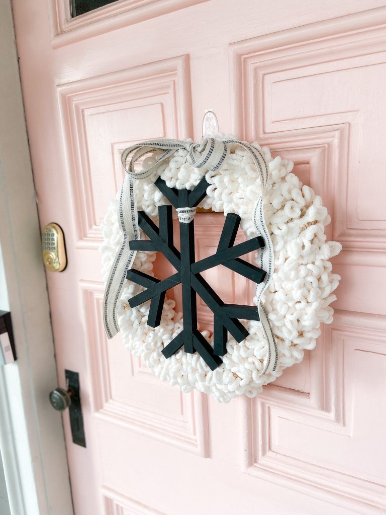 DIY Winter Wood and Yarn Snowflake Wreath. Celebrate winter with an easy yarn-wrapped wreath featuring a handmade giant snowflake!