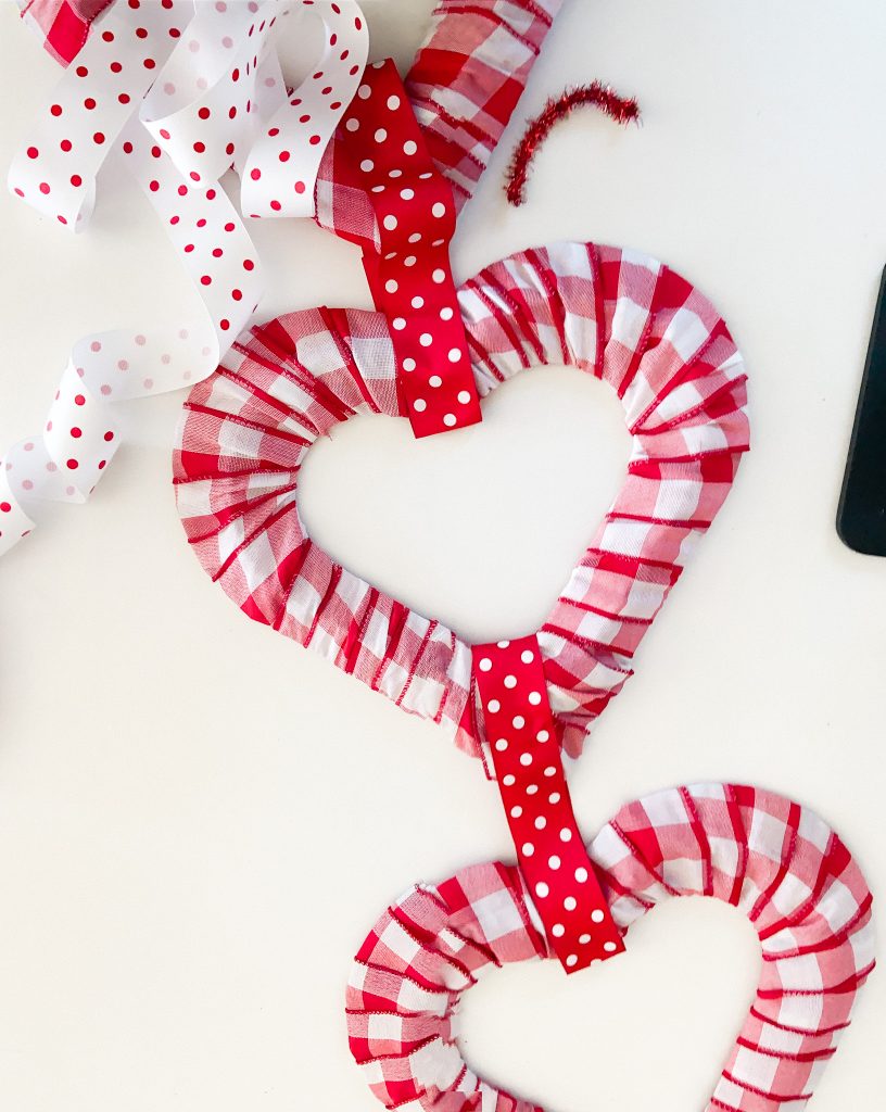 Dollar Store Triple Heart Valentine's Day Wreath. Brighten up February with an inexpensive and triple dollar store heart wreath.