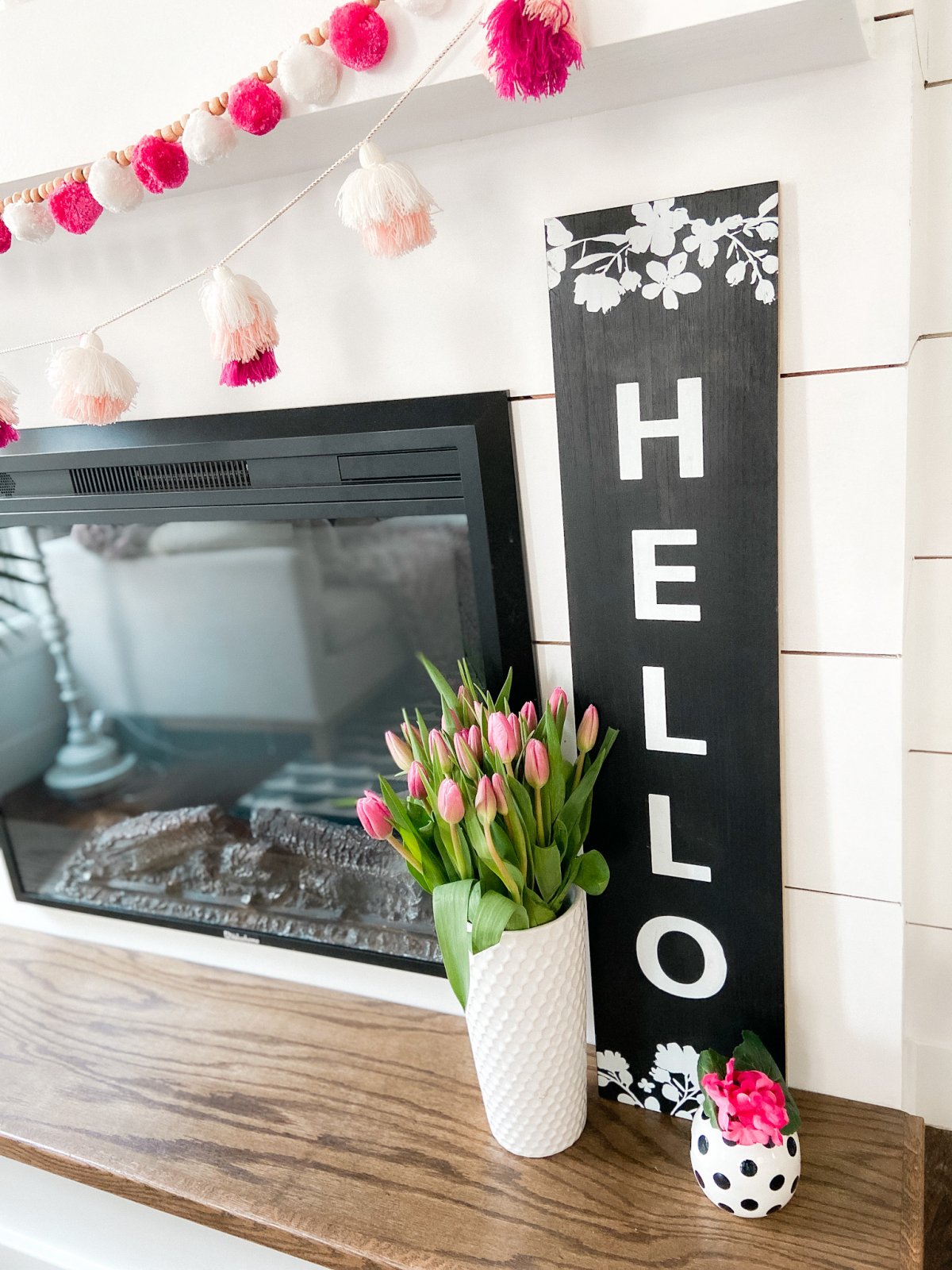 Colorful Spring Mantel with DIY Chalkboard Sign. Add spring color to your home with bright flowers, pretty accents and a DIY chalkboard!