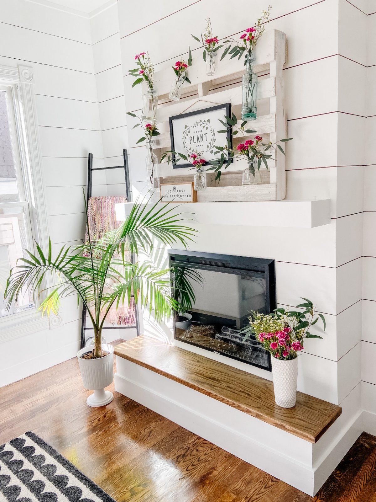 DIY Spring Pallet Flower Mantel. Turn a free pallet into a beautiful vertical flower and sign display that can be changed out seasonally!