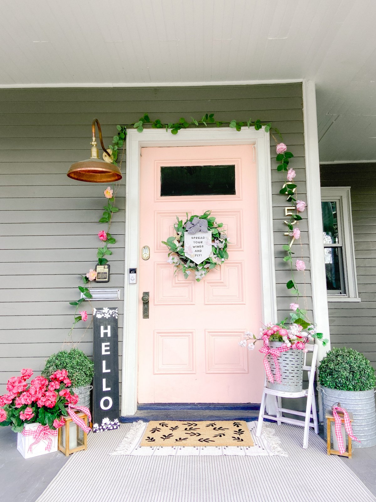 Spring Butterfly Pennant Wreath. Celebrate spring by making this simple wreath with butterflies cut out of cardstock and a big pennant in the middle and a spring saying!