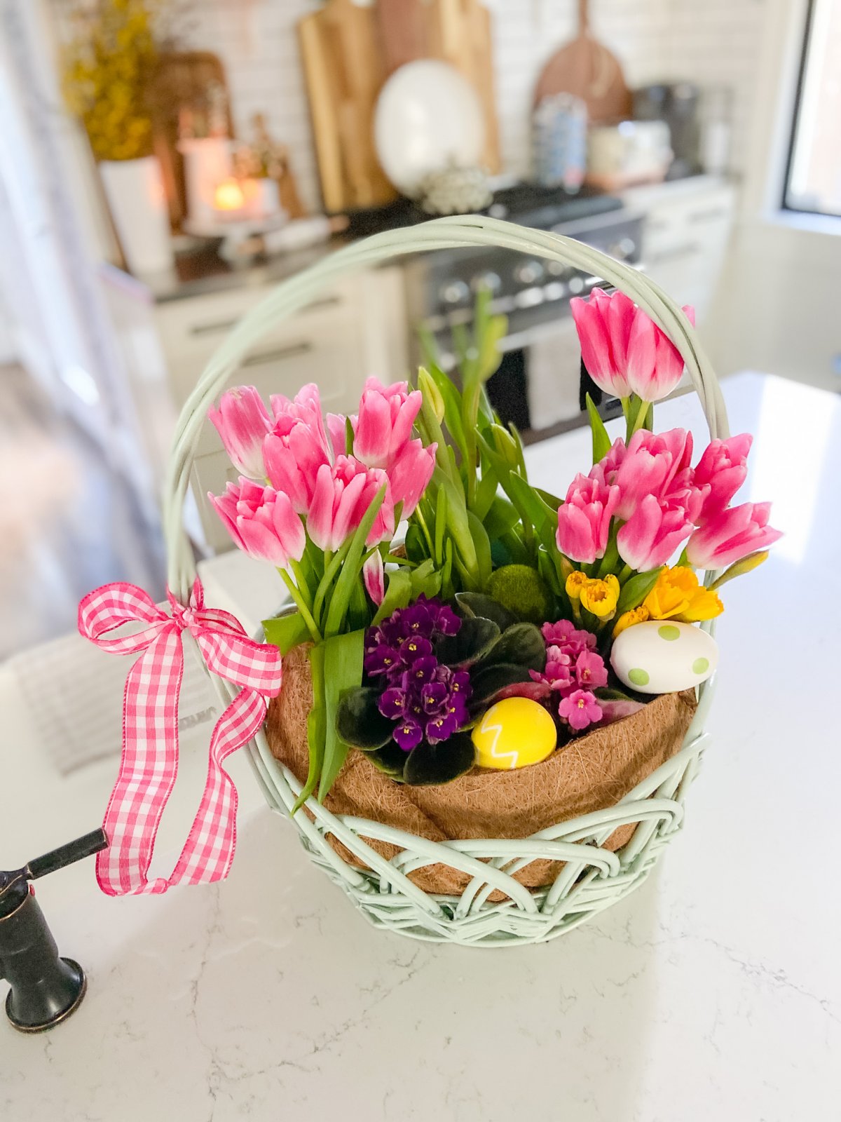 Easter Basket Living Floral Centerpiece. Take an Easter basket, plant flowers inside and cover with a dollar store coir liner for a beautiful spring living centerpiece.