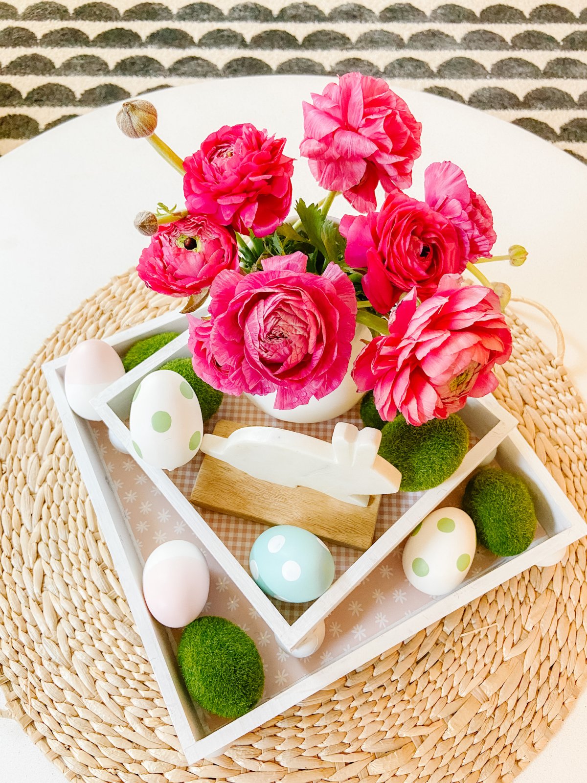 DIY Spring Footed Stacking Tray Centerpiece. Add ball feet to simple wood boxes, add scrapbook paper and layer with fresh flowers and spring items for a pretty centerpiece! 