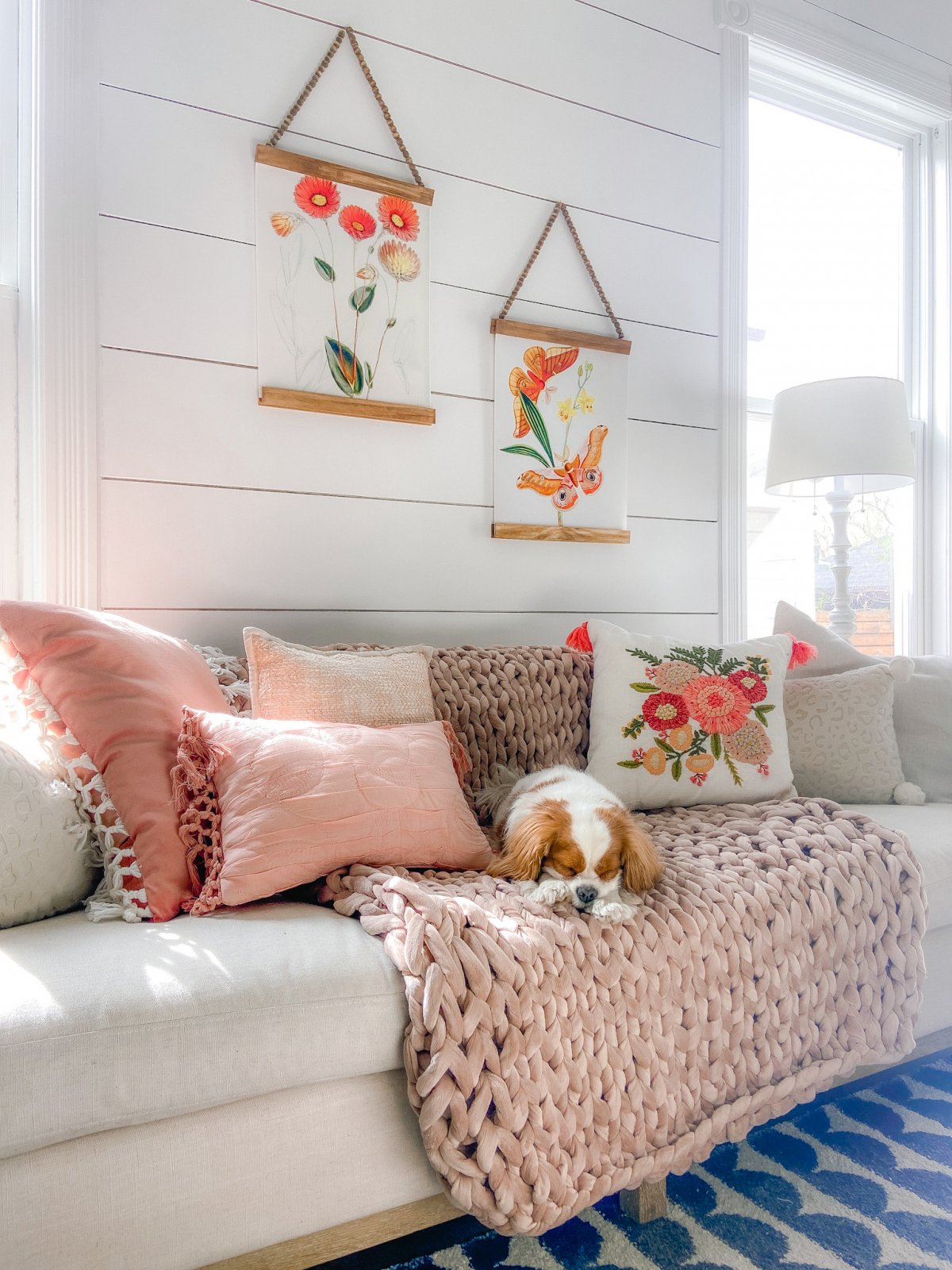 Spring Botanical Prints with DIY Beaded Hangers. Bright flowers match a spring pillow on a pink blanket. 