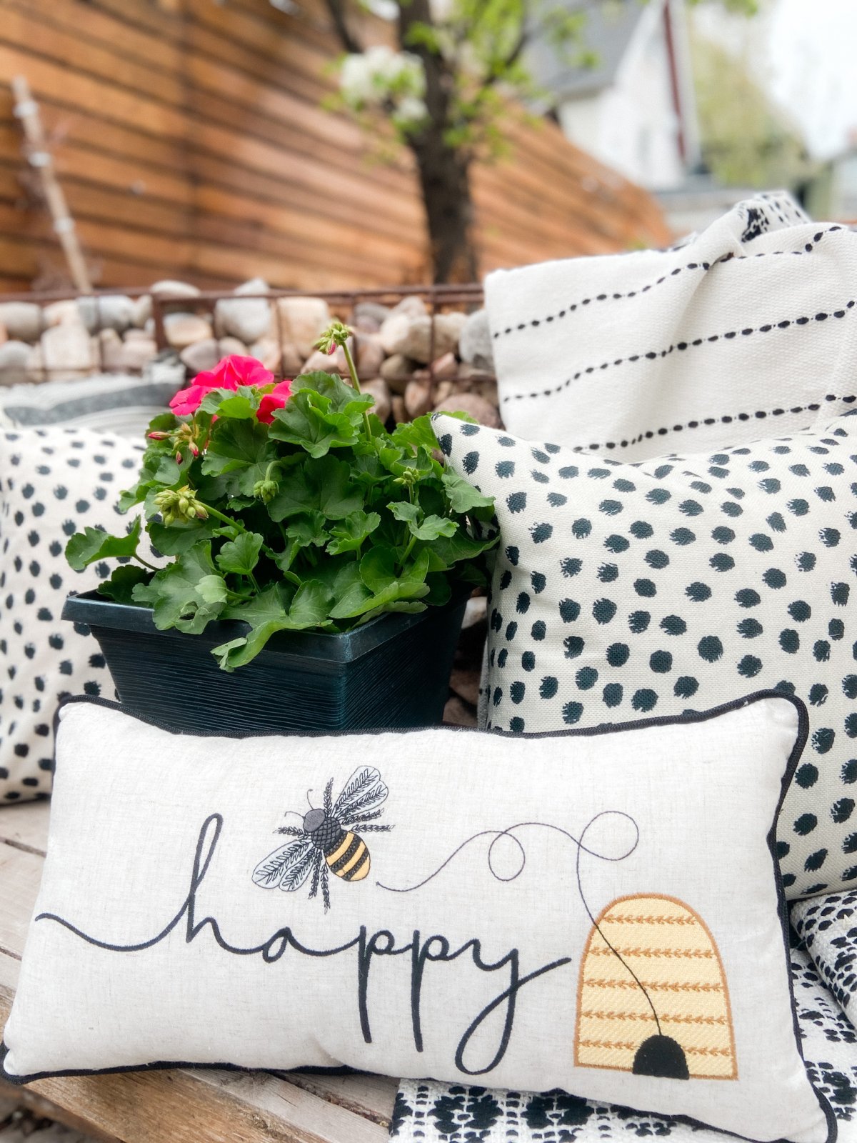 DIY Beehives and Beehive Backyard Inspo! Create cute and inexpensive beehives, add beehive pillows and create a hanging basket garden for a beautiful summer patio!